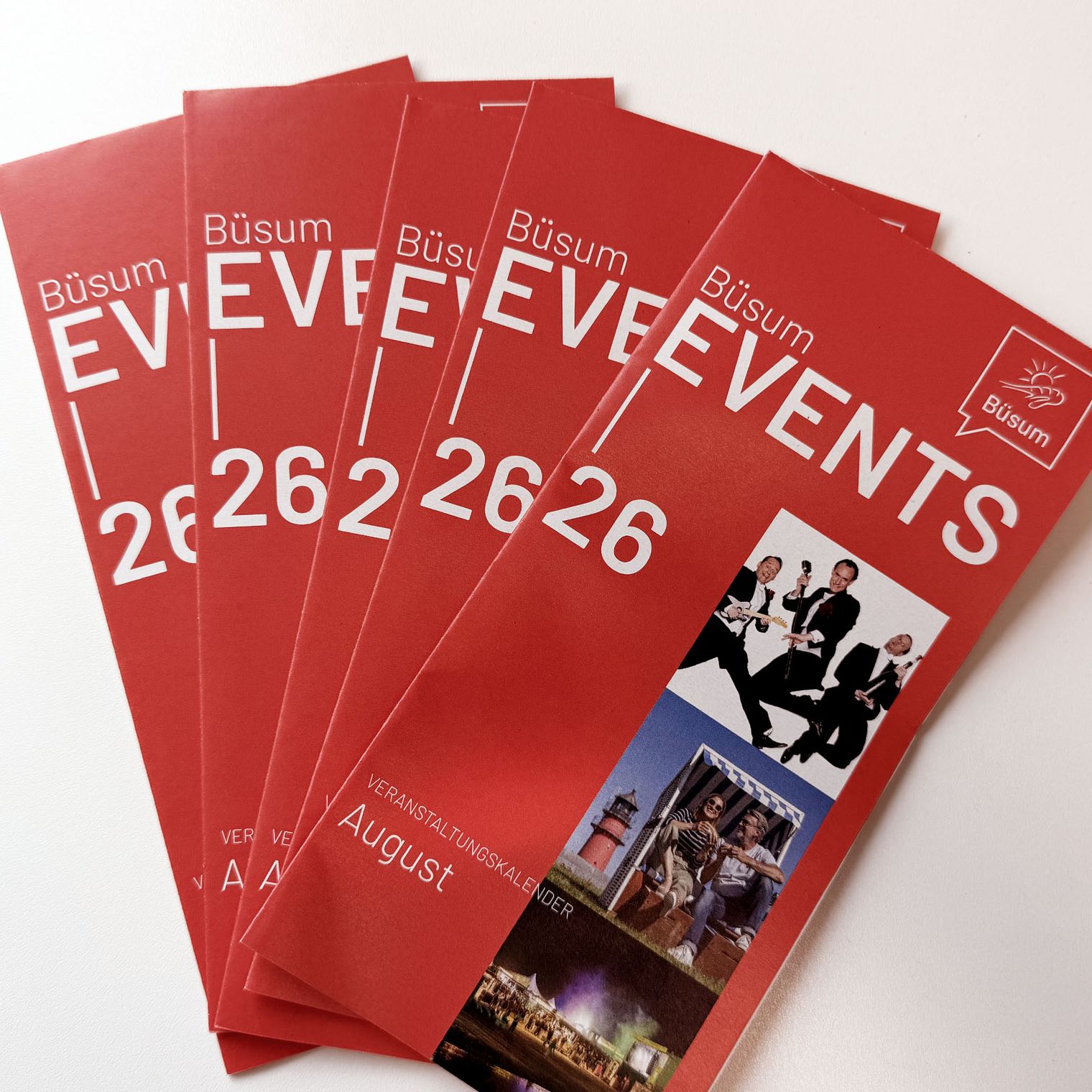 Mehrere Eventsflyer auf einem Tisch ausgebreitet.